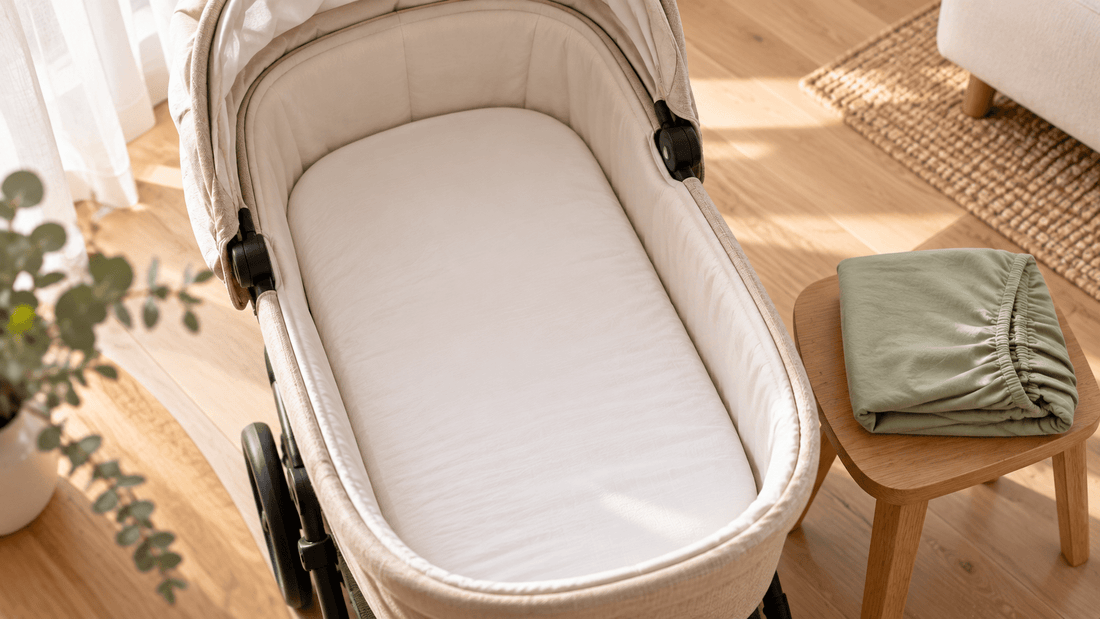 Spannbettlaken für den Kinderwagen straff auf der Matratze einer Babywanne