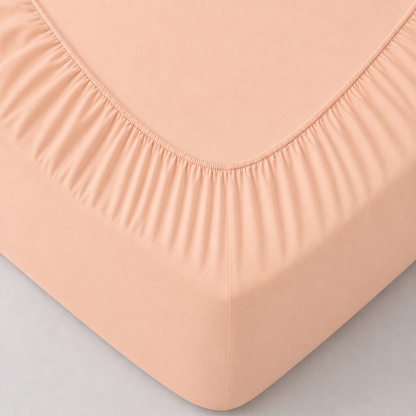 Detailansicht Mako-Jersey Spannbettlaken apricot: Ecke und Stoffstruktur in Nahaufnahme